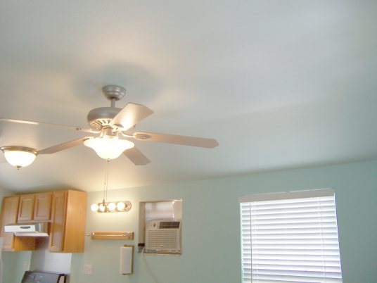 Ceiling fan cools whole living room. Kitchen has hood vented outside. Bath has fan vented outside.